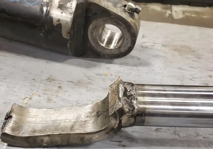A complete damaged Clark forklift tilt cylinder